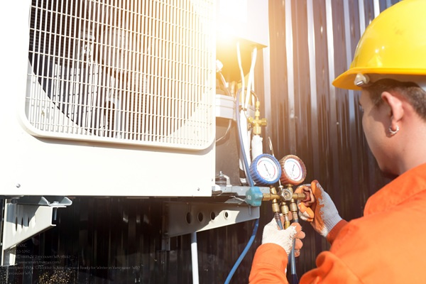 A Professional Air Conditioner Technician Checking The Refrigera